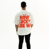 Back view of BO RAE How Lucky Are We oversized unisex adult T-shirt in white featuring large Red graphic print