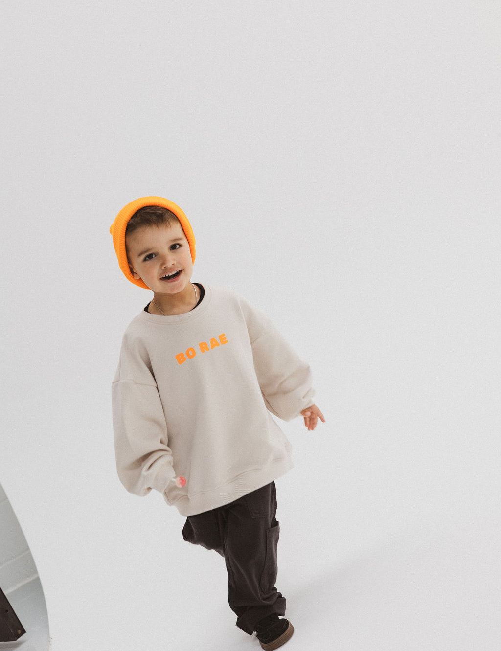 Child wearing BO RAE How Lucky Are We oversized kids jumper in beige