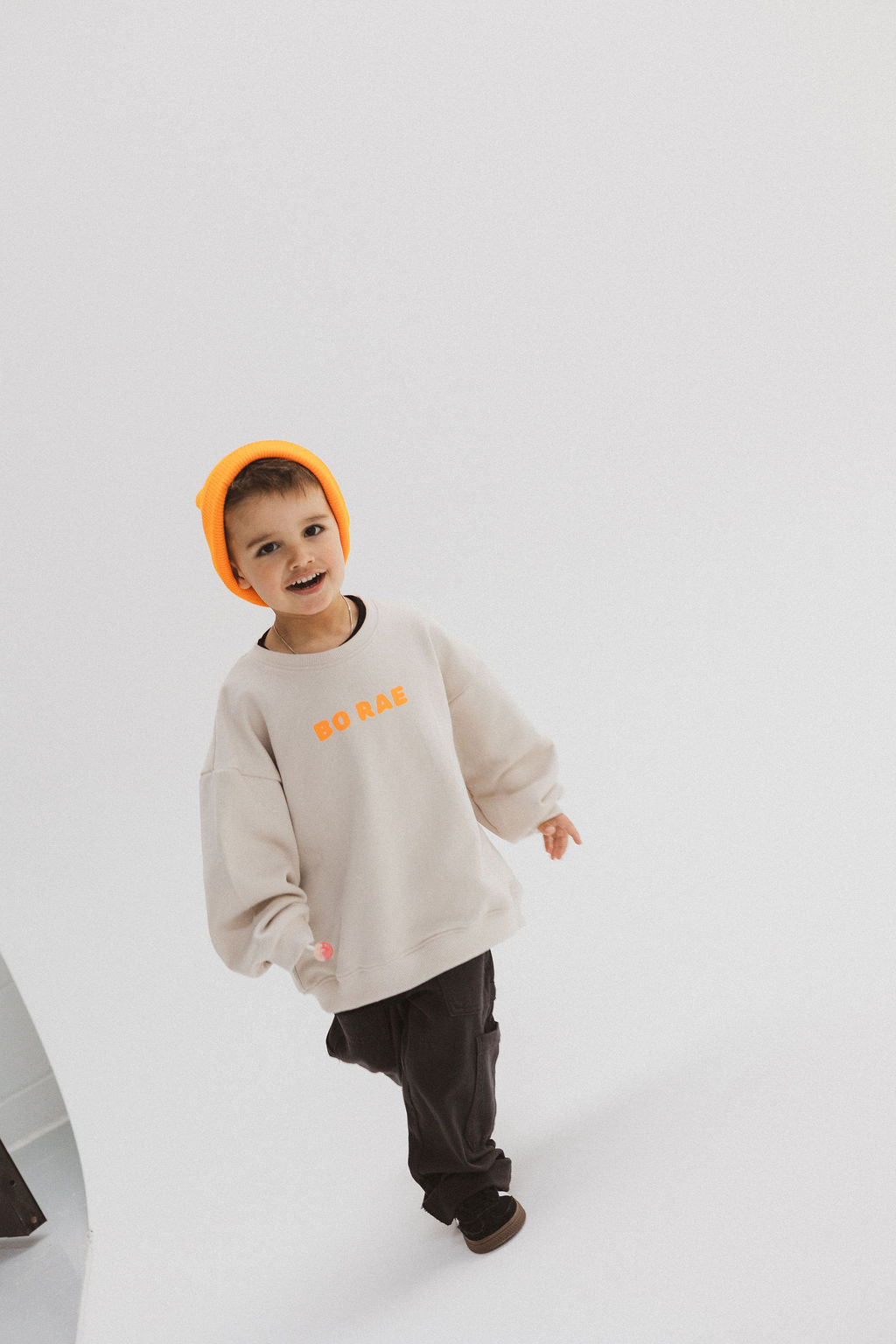 Child wearing BO RAE How Lucky Are We oversized kids jumper in beige