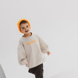 Child wearing BO RAE How Lucky Are We oversized kids jumper in beige