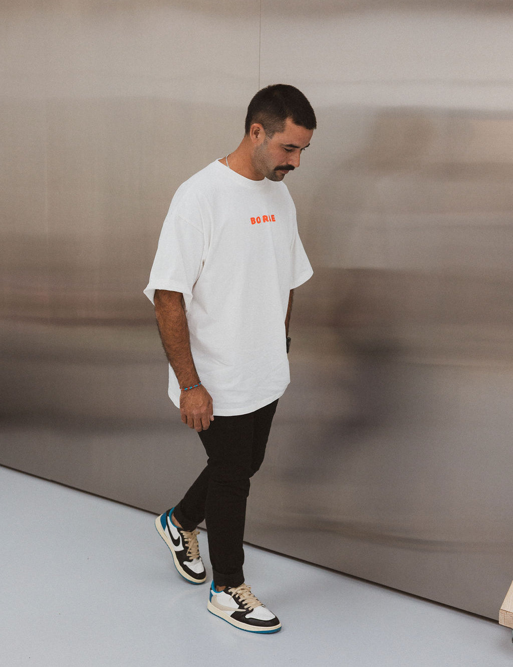 Model wearing BO RAE How Lucky Are We oversized unisex adult T-shirt in white.