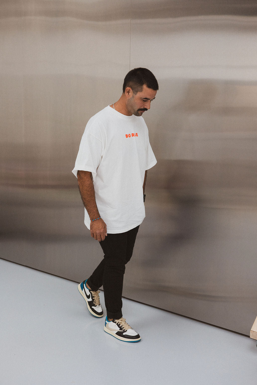 Model wearing BO RAE How Lucky Are We oversized unisex adult T-shirt in white.