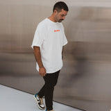 Model wearing BO RAE How Lucky Are We oversized unisex adult T-shirt in white.