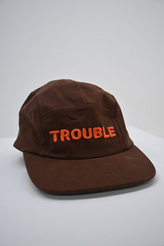 BO RAE Trouble Hat kids cotton camp cap in brown with orange embroidered logo, angled front view
